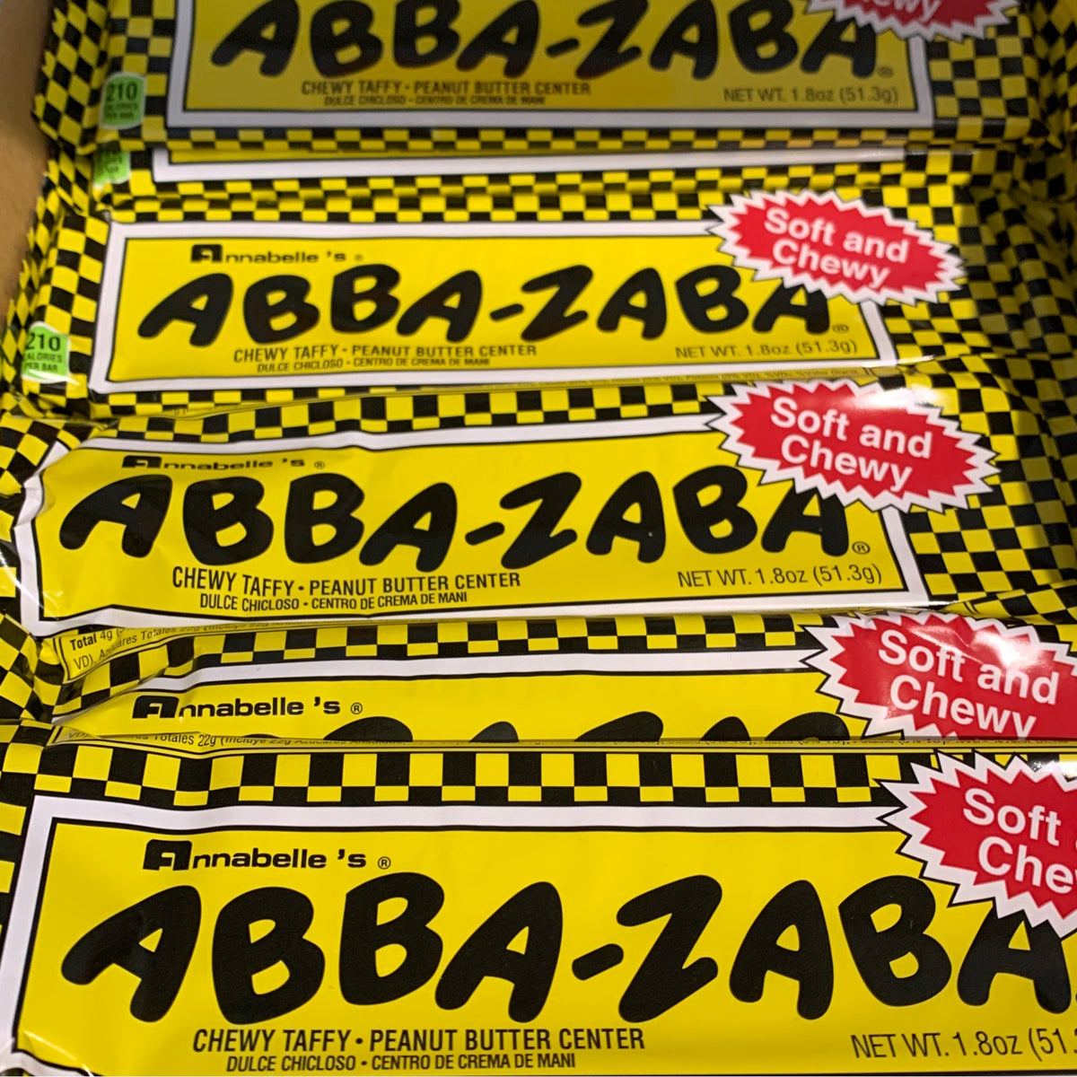 Packaged Abba Zaba chewy taffy bars with a yellow and black design, featuring the product name and 'Soft and Chewy' label.