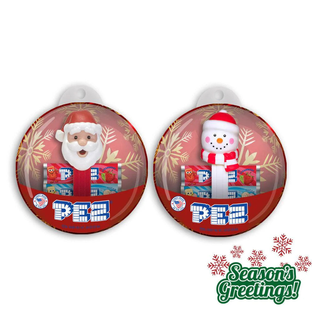 Two Christmas-themed PEZ dispensers with Santa and snowman characters on a white background.