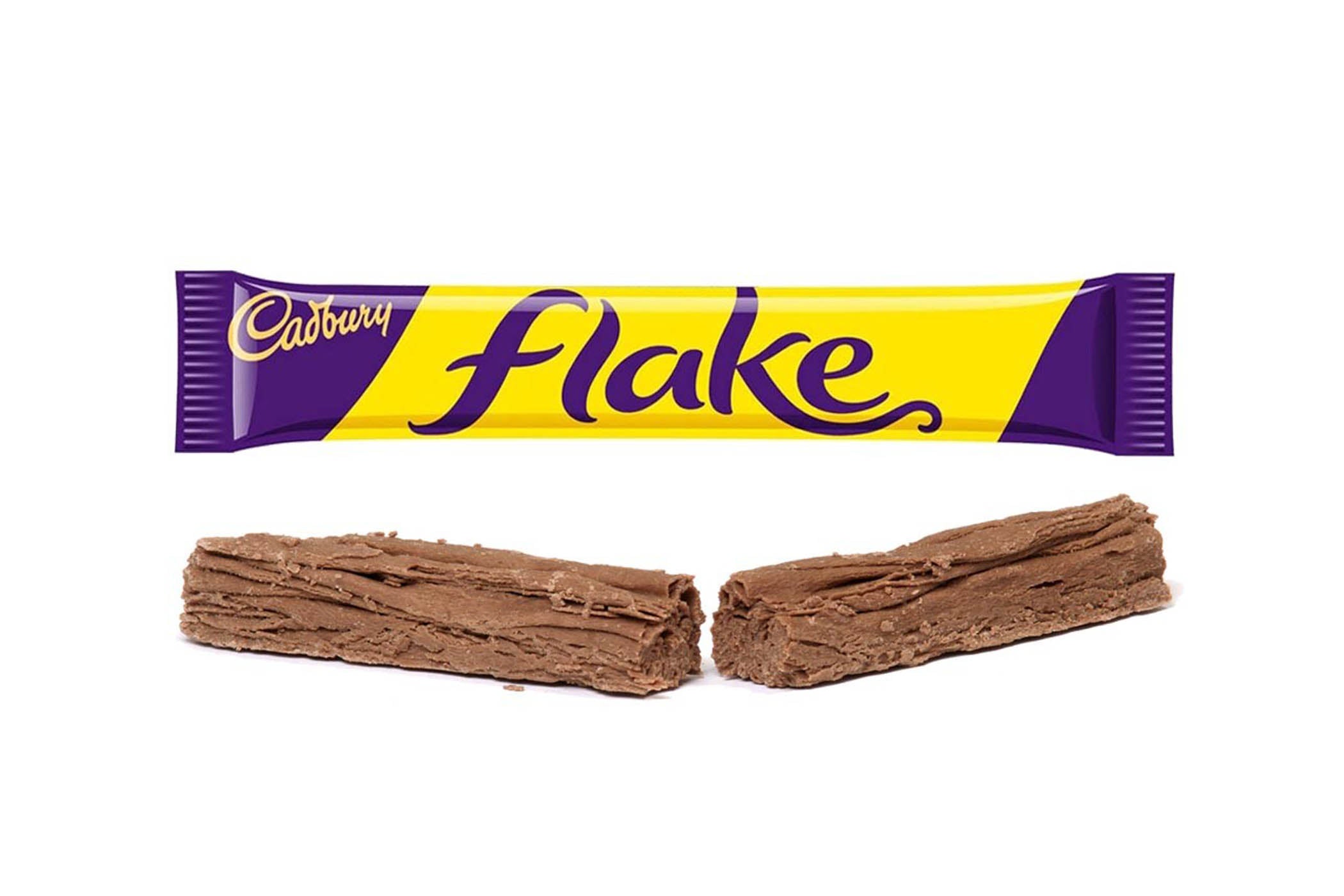 A Cadbury Flake chocolate bar wrapper in purple and yellow is shown above two broken pieces of the chocolate bar on a plain white background.